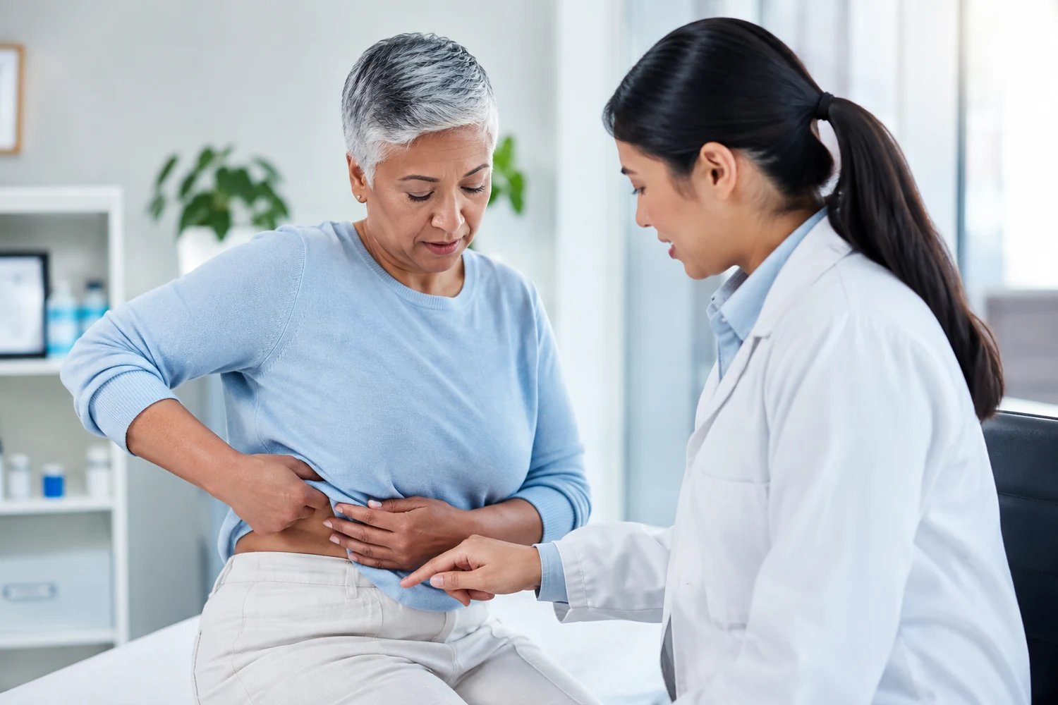 Doctor speaking with a patient who is describing side and abdominal discomfort