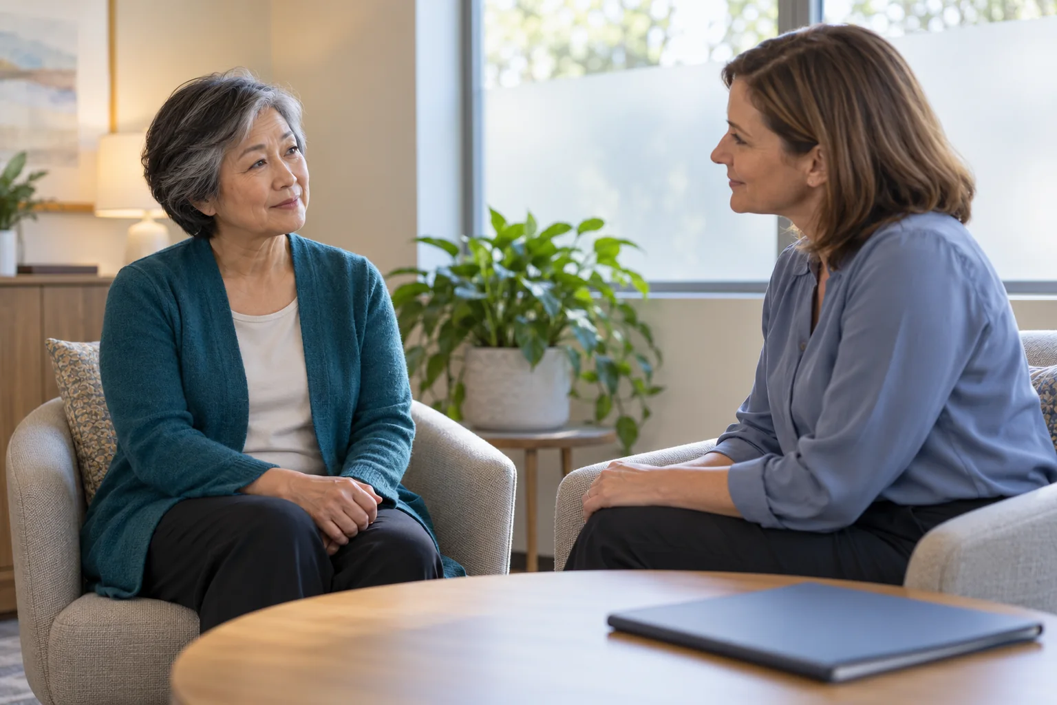 An adult discussing health concerns in a quiet consultation room.